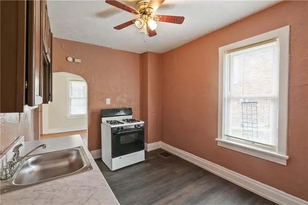 a kitchen with a stove oven and sink