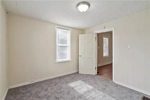 an empty room with windows and closet