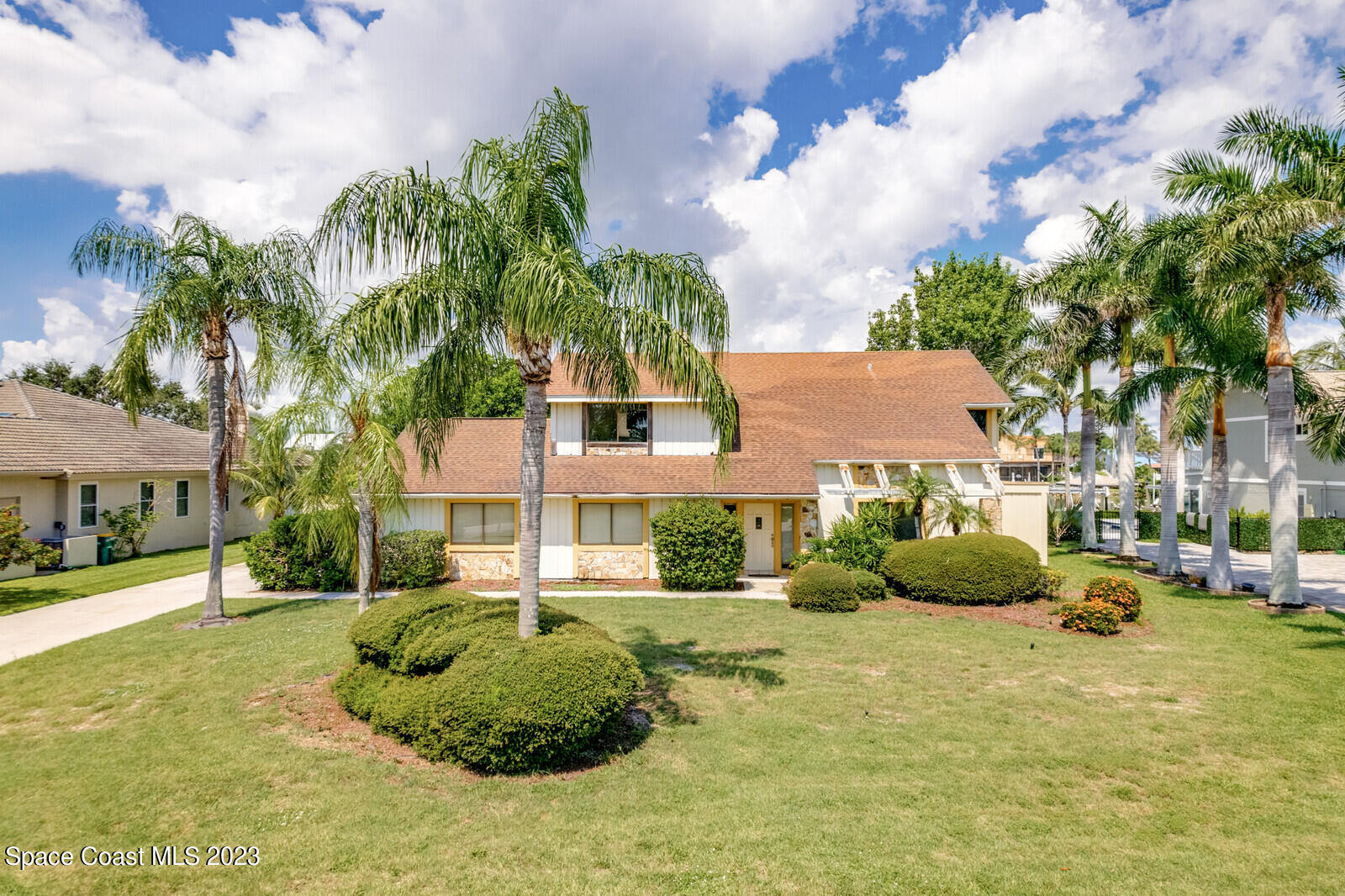 618 Tortoise Way Satellite Beach, FL 32937 - Photo 1 of 21 a front view of a house with a garden and trees