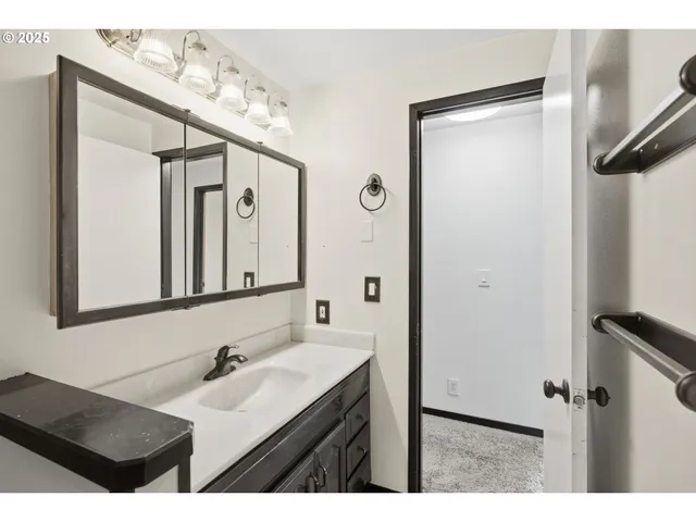 a bathroom with a sink vanity and a mirror