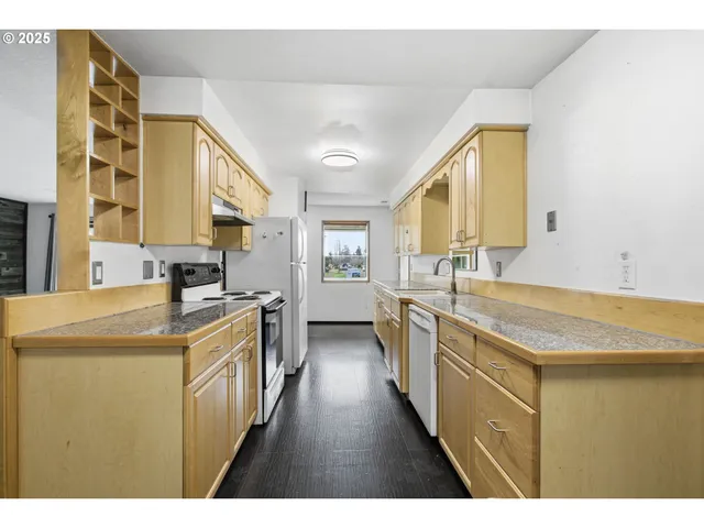 a kitchen with stainless steel appliances granite countertop a sink and a stove