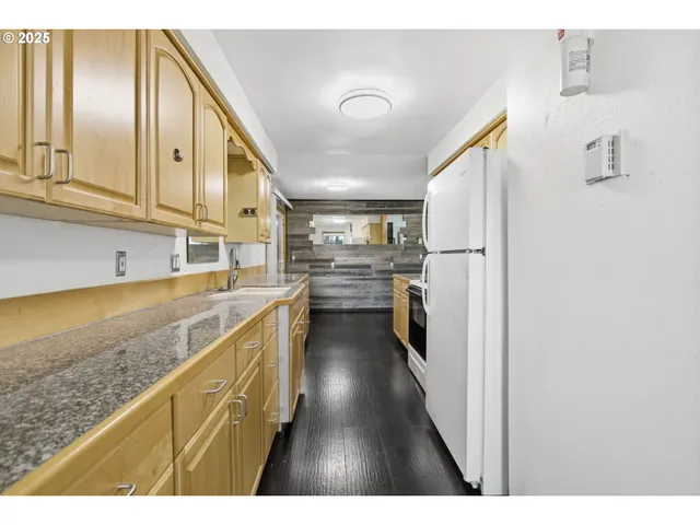a kitchen with refrigerator and cabinets