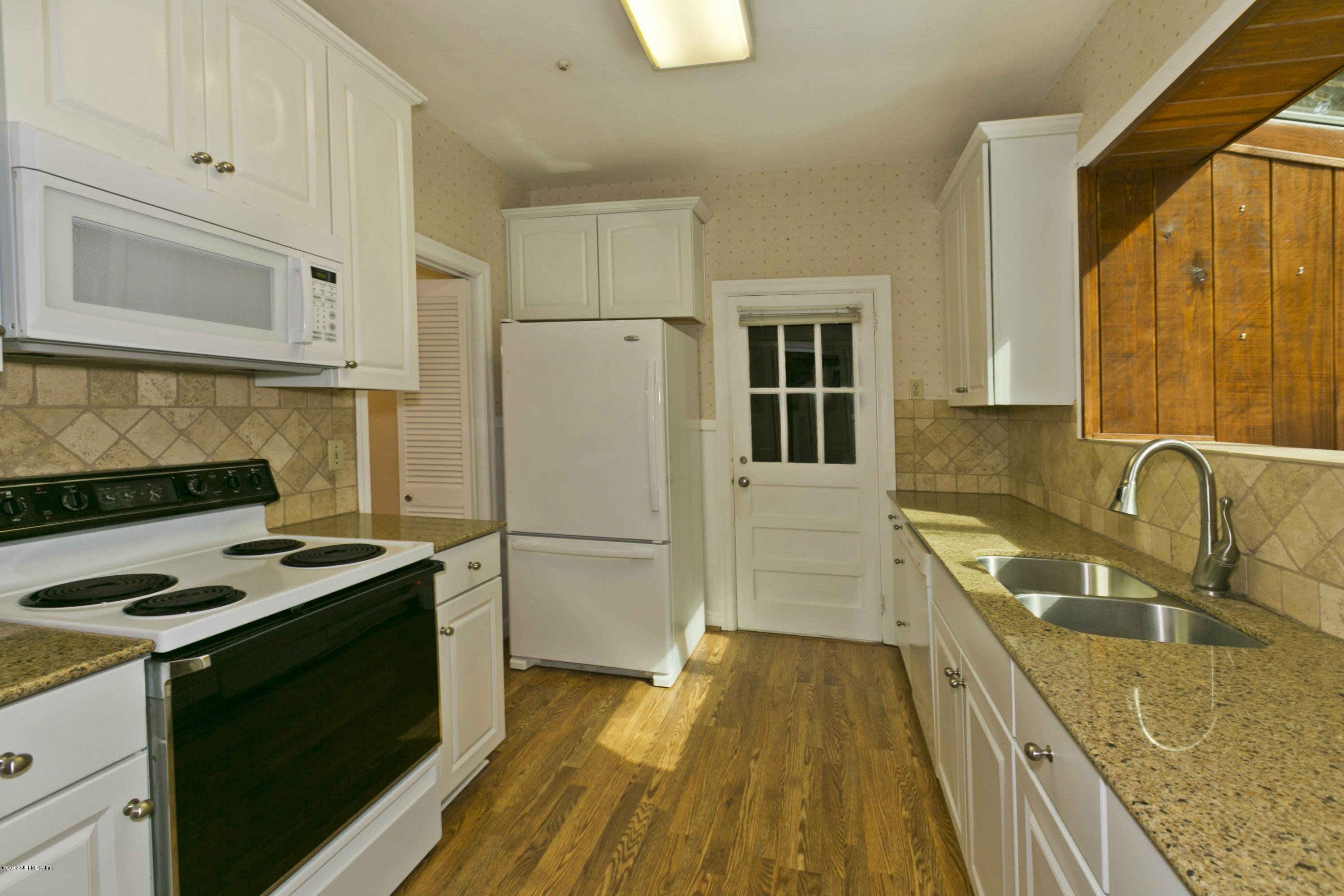 1427 Mapleton Road Jacksonville, FL 32207 - Photo 8 of 25 a kitchen with a sink a stove and refrigerator
