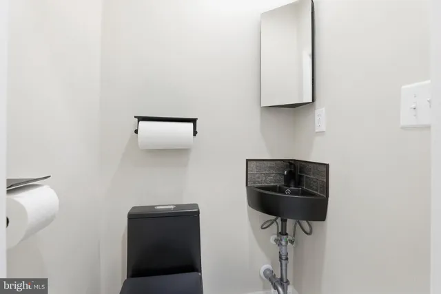 a view of empty room with fireplace wooden floor and windows