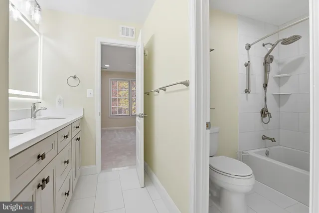 an empty room with an entryway and fan