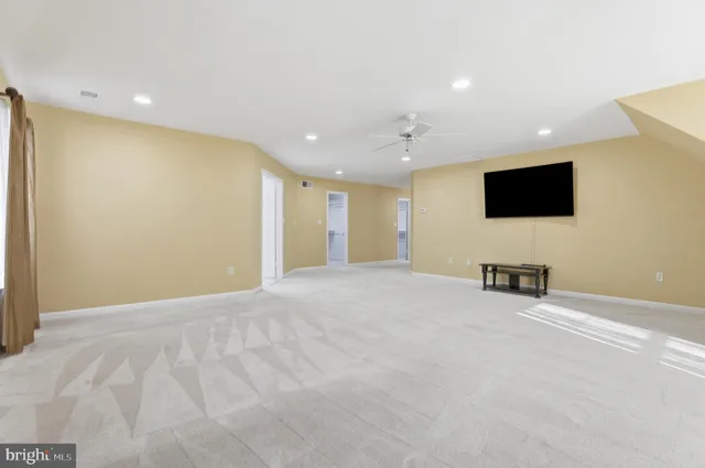 a living room with pool table and a flat screen tv