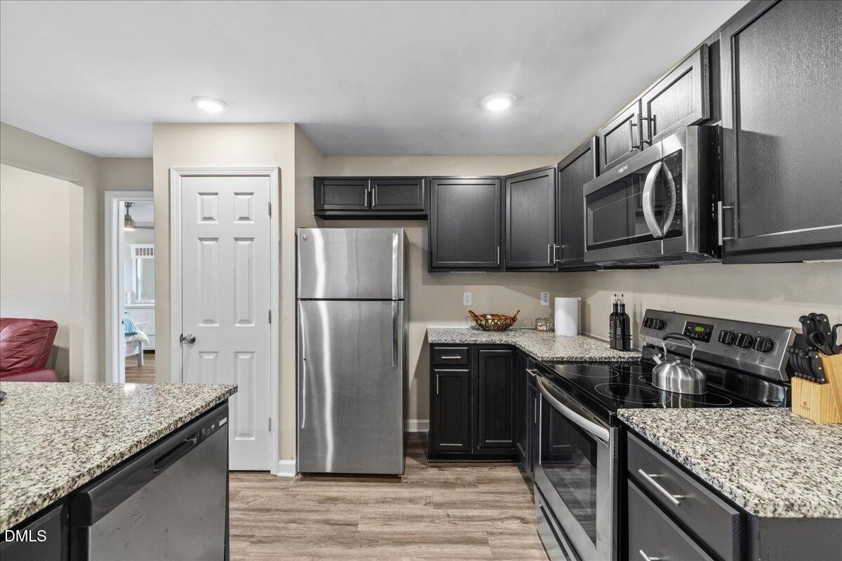 513 Broad Street Roxboro, NC 27573 - Photo 11 of 33 a kitchen with stainless steel appliances granite countertop a refrigerator a stove and a sink