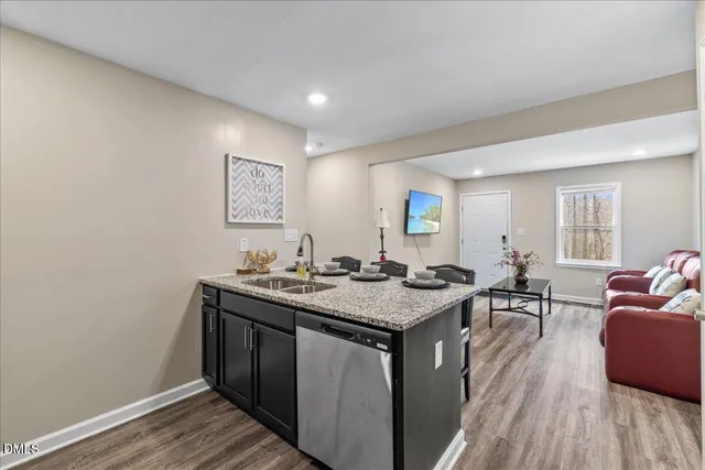 a view of living room with granite countertop furniture and wooden floor