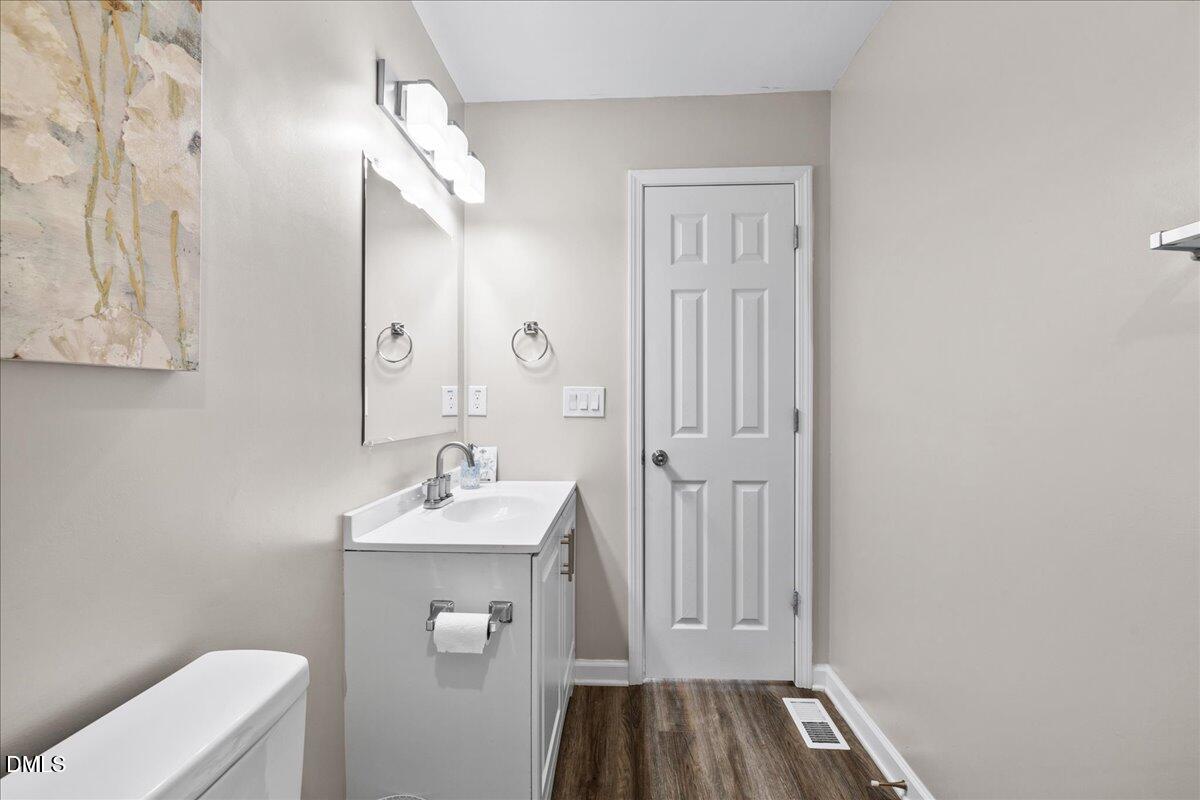513 Broad Street Roxboro, NC 27573 - Photo 19 of 33 a bathroom with a sink a toilet and mirror