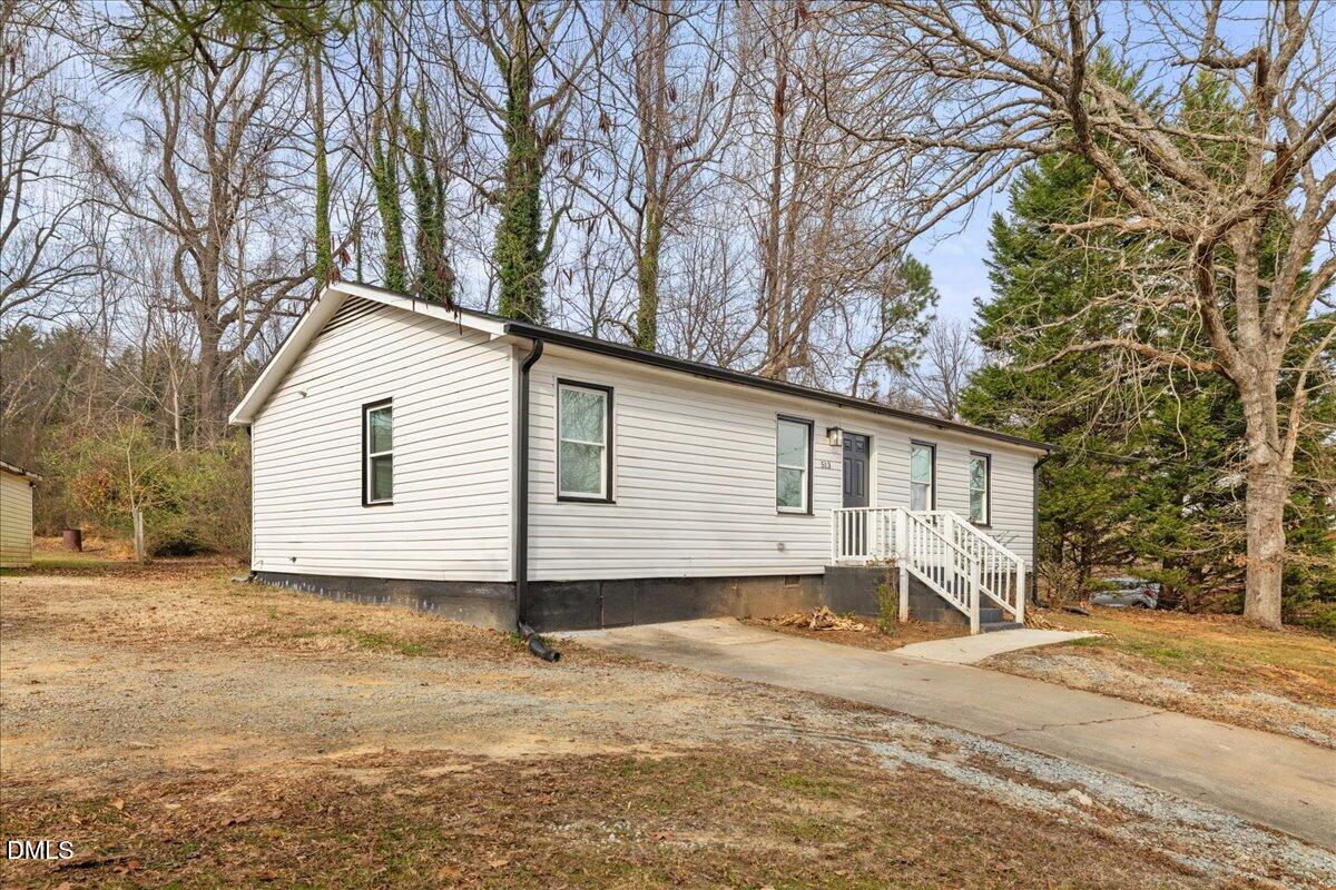 513 Broad Street Roxboro, NC 27573 - Photo 2 of 33 a view of a house with a yard covered in snow
