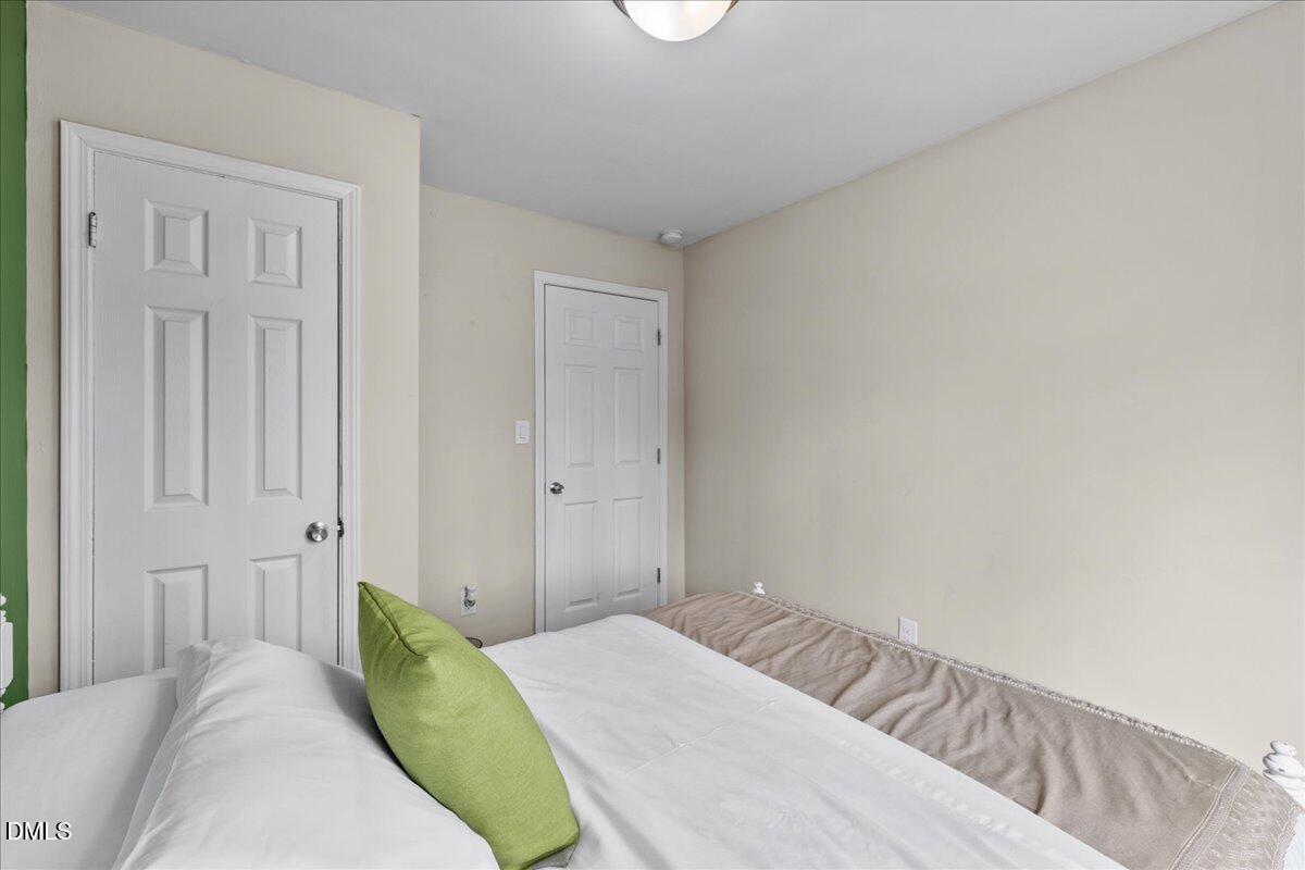 513 Broad Street Roxboro, NC 27573 - Photo 22 of 33 a bedroom with a bed and pillows