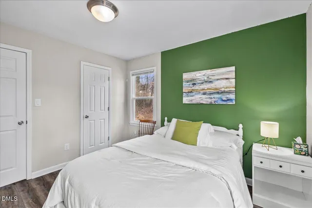 a bedroom with a bed and a window