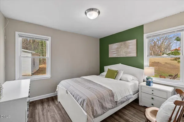 a bedroom with a bed and lamp