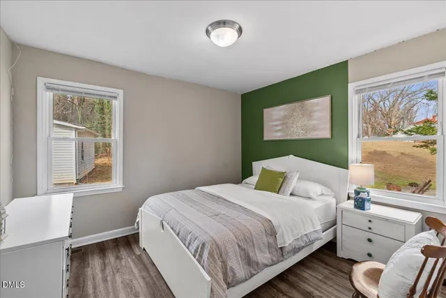 a bedroom with a bed and lamp