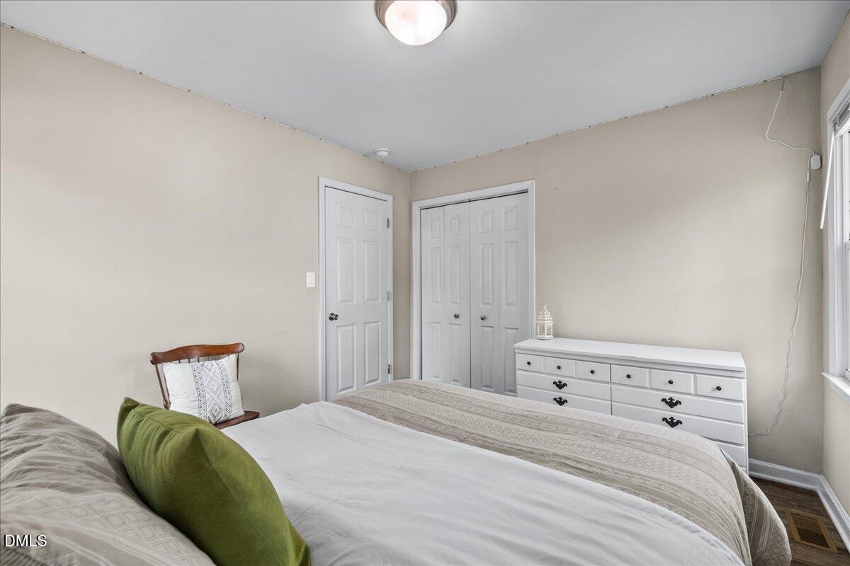 513 Broad Street Roxboro, NC 27573 - Photo 26 of 33 a bedroom with a bed and lamp