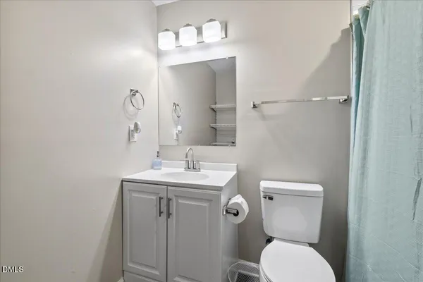 a bathroom with a shower and a toilet