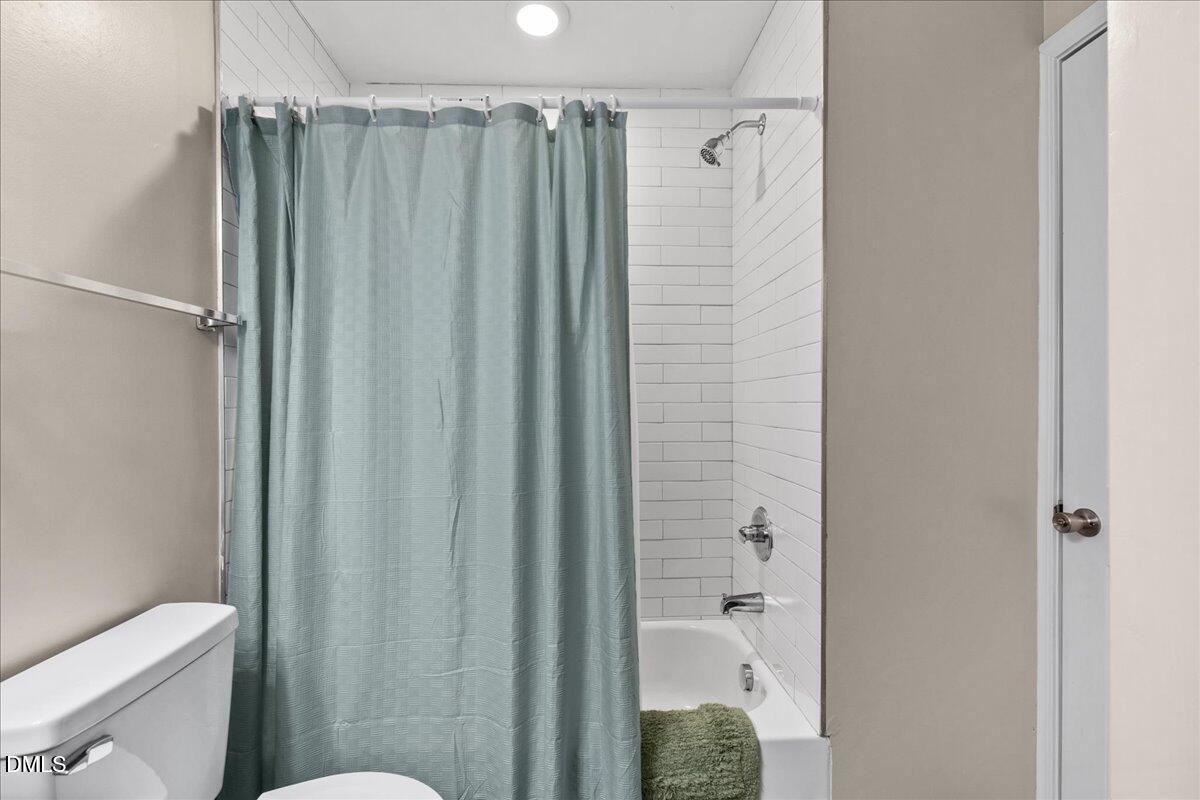 513 Broad Street Roxboro, NC 27573 - Photo 28 of 33 a bathroom with a shower and a toilet