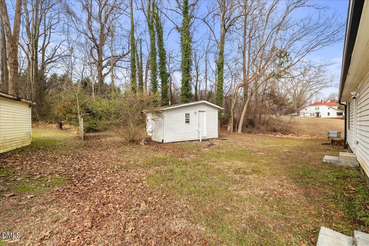 513 Broad Street Roxboro, NC 27573 - Photo 29 of 33 a backyard of a house with lots of green space
