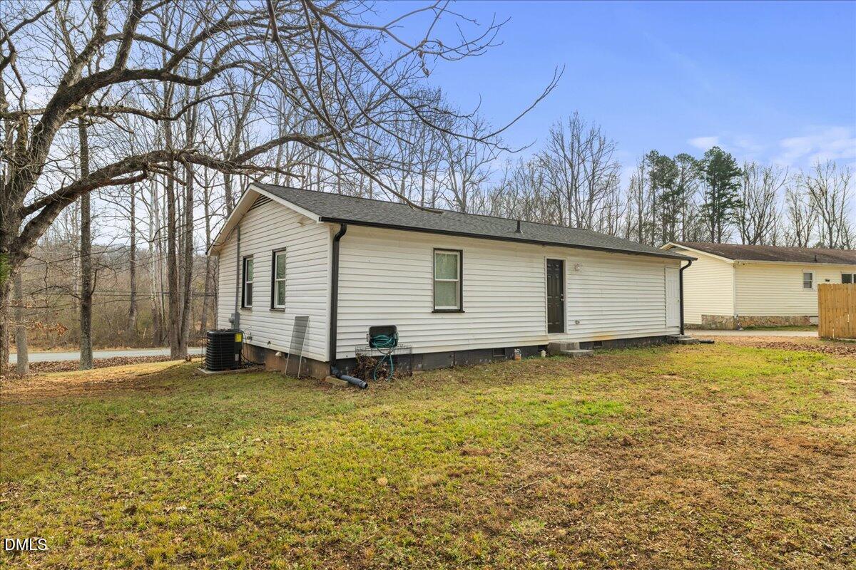 513 Broad Street Roxboro, NC 27573 - Photo 33 of 33 a view of a backyard with a large tree