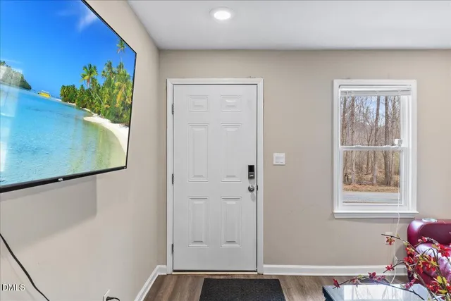 a view of an entryway with wooden floor