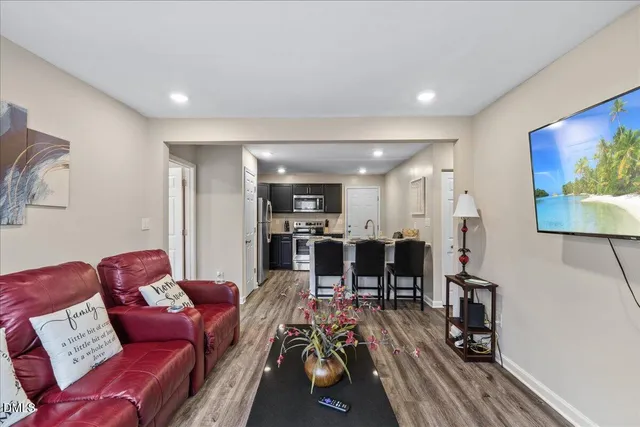a living room with furniture and wooden floor
