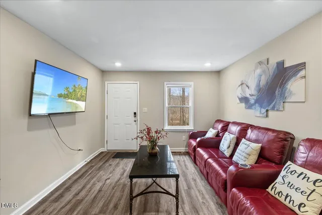 a living room with furniture a couch and a flat screen tv