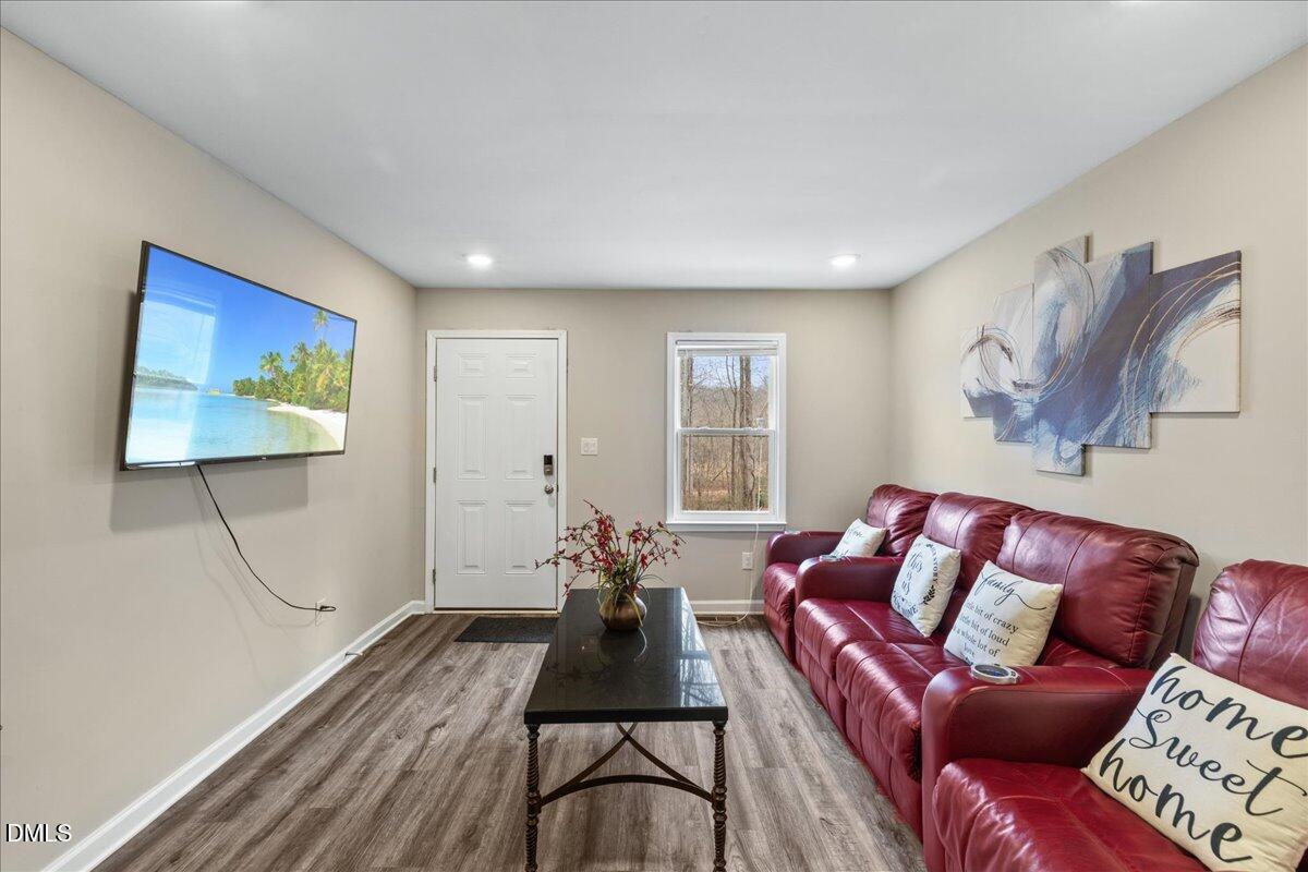 513 Broad Street Roxboro, NC 27573 - Photo 7 of 33 a living room with furniture a couch and a flat screen tv