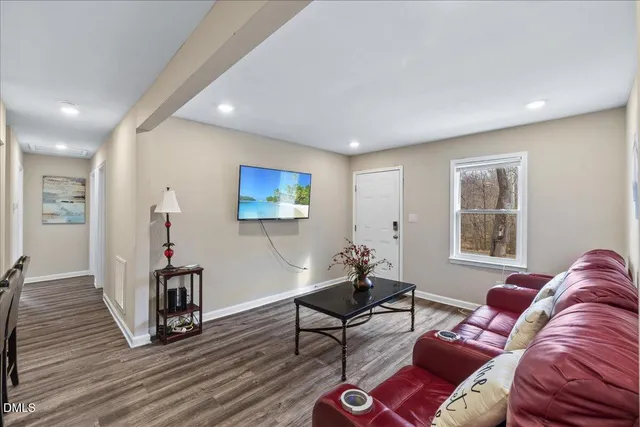 a living room with furniture a couch and a window