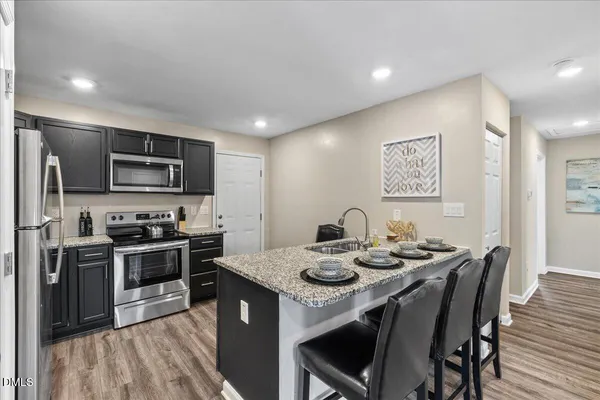 a kitchen with sink microwave and stove