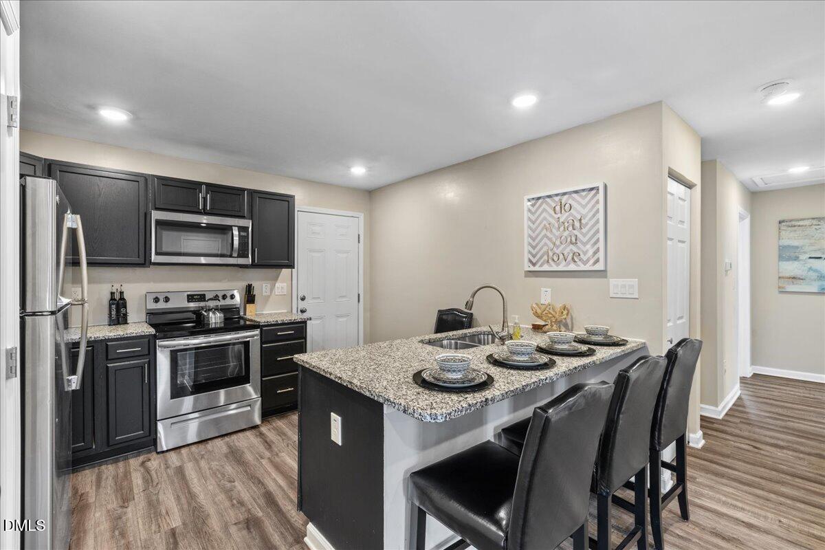 513 Broad Street Roxboro, NC 27573 - Photo 9 of 33 a kitchen with sink microwave and stove