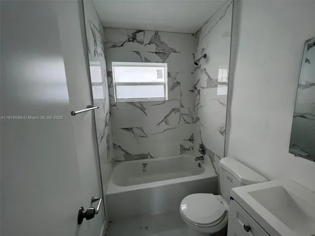 a bathroom with a toilet sink and bathtub
