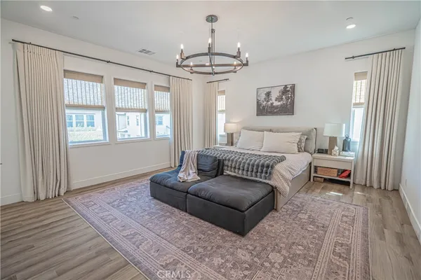 a living room with furniture a window and a chandelier