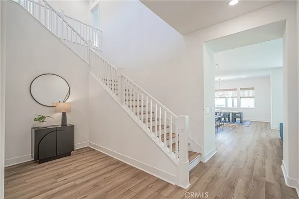 a view of entryway and hall with wooden floor