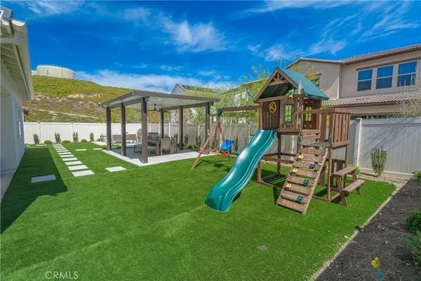 a view of a backyard with wooden floor and a yard