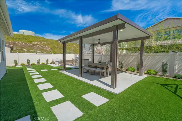 a view of a house with a backyard porch and sitting area
