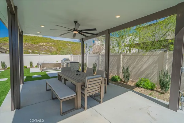 a view of an house with backyard and sitting area