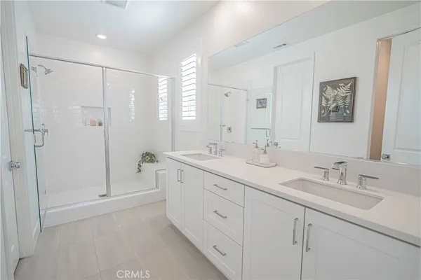 a kitchen with kitchen island a wooden floor and white appliances