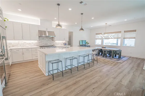 a kitchen with stainless steel appliances a stove microwave and refrigerator