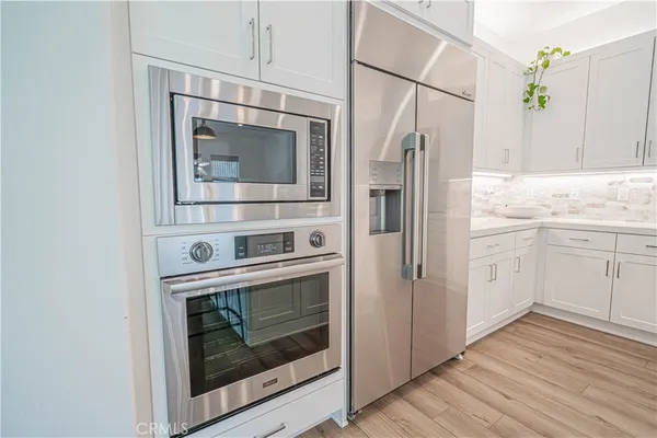 a kitchen with a sink stove cabinets and refrigerator