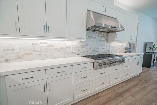 a kitchen with a sink stove and refrigerator