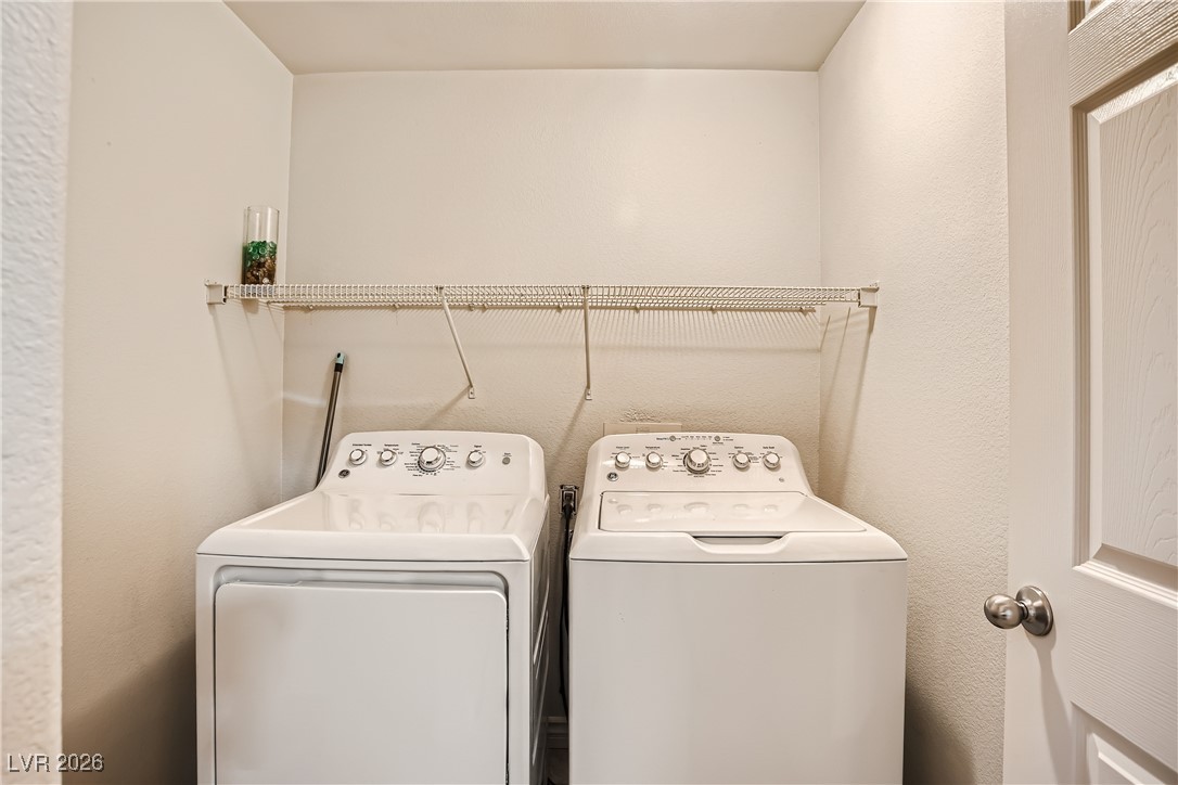 7701 West Robindale Road, Unit 149 Las Vegas, NV 89113 - Photo 19 of 22 Washroom with a textured wall and independent washer and dryer