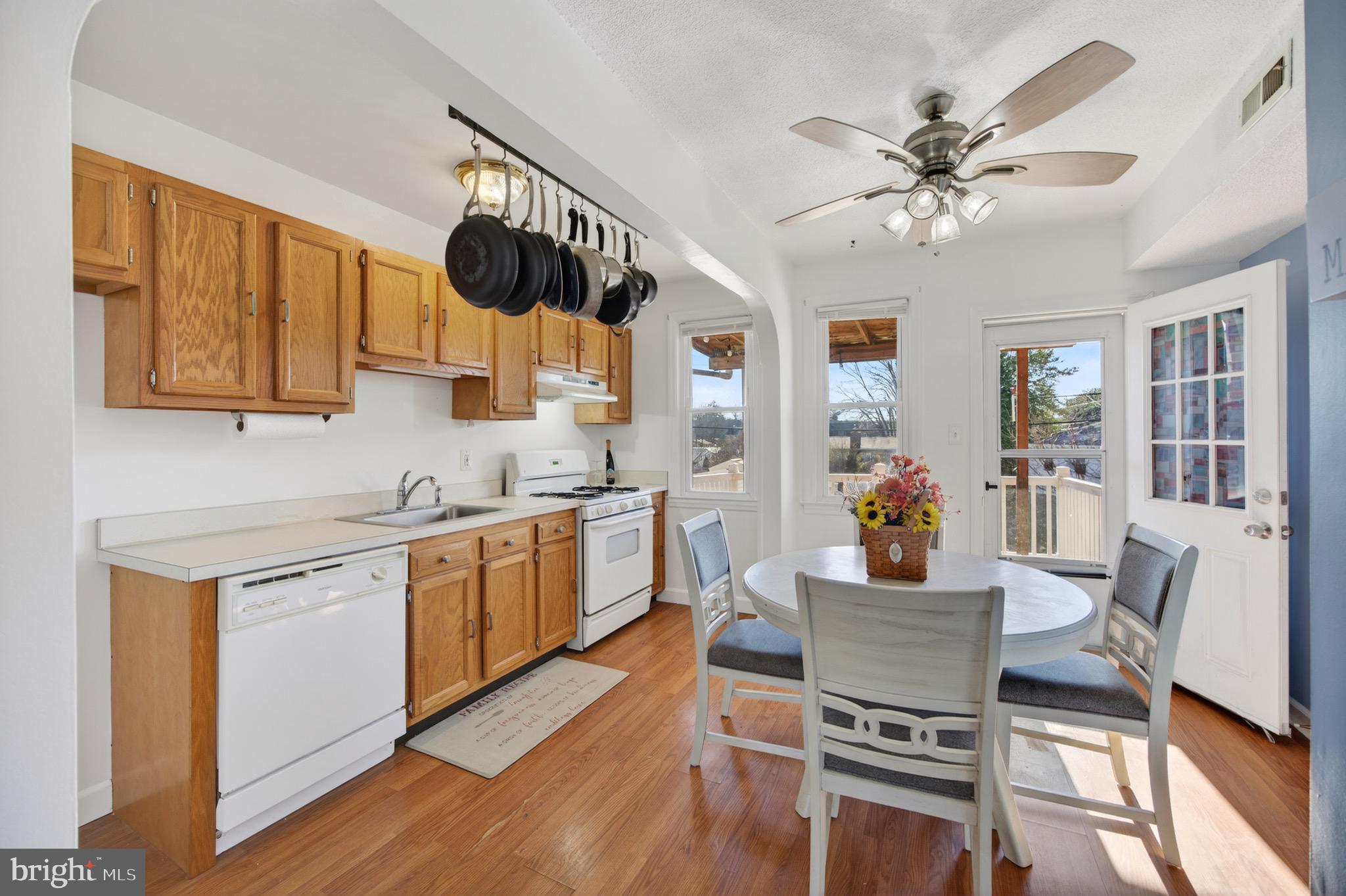 3579 Benzinger Road Baltimore, MD 21229 - Photo 11 of 34 a kitchen with a table chairs cabinets and wooden floor