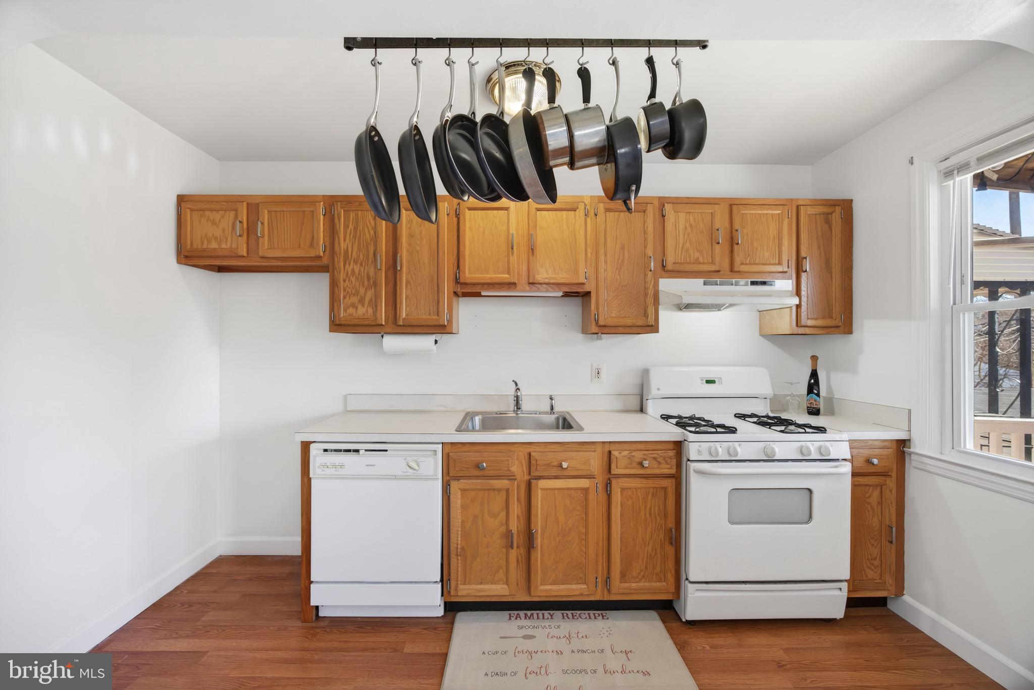 3579 Benzinger Road Baltimore, MD 21229 - Photo 13 of 34 a kitchen with a stove a sink and a microwave