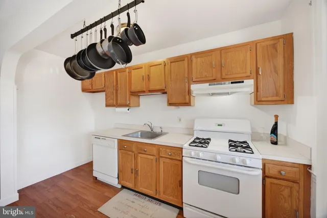 a kitchen with stainless steel appliances a sink a stove and cabinets