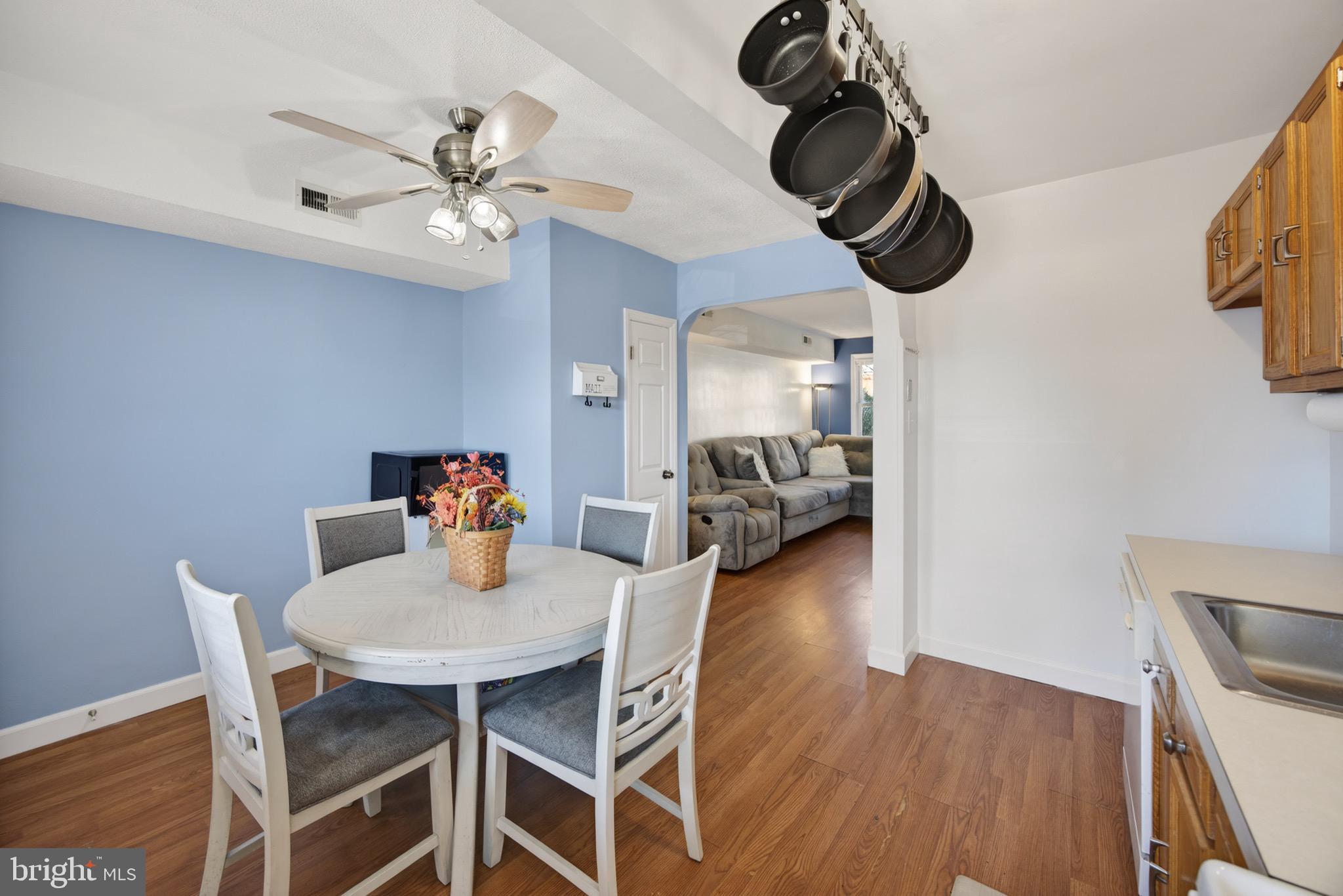 3579 Benzinger Road Baltimore, MD 21229 - Photo 16 of 34 a view of a dining room with furniture wooden floor and chandelier