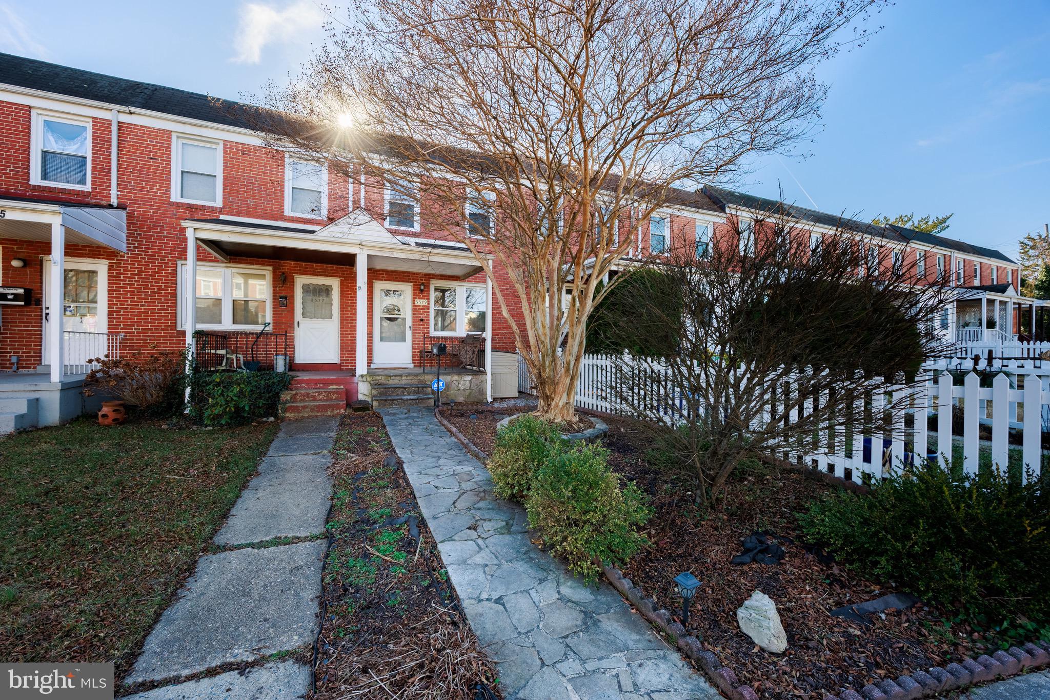 3579 Benzinger Road Baltimore, MD 21229 - Photo 2 of 34 a front view of a house with a yard and potted plants