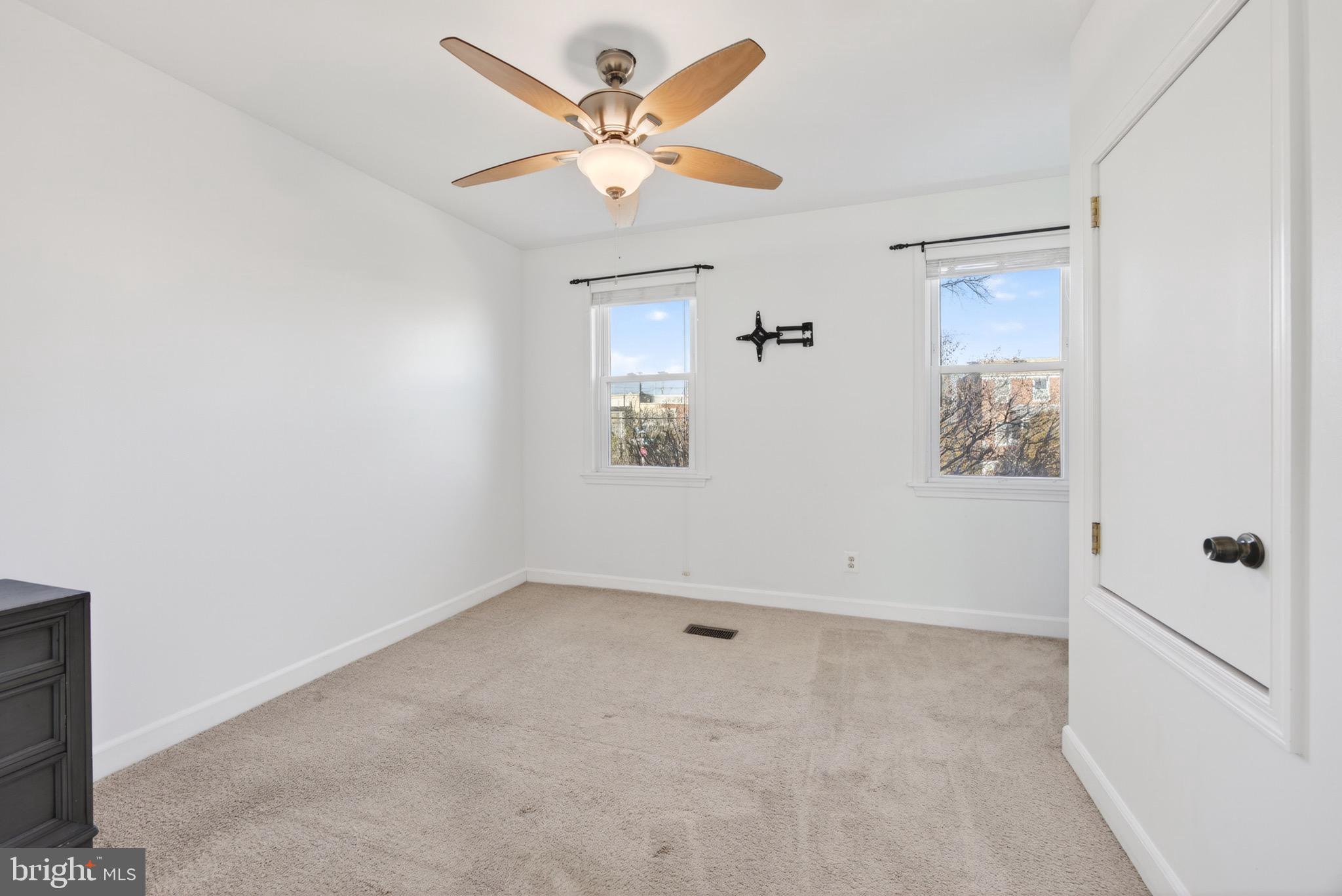3579 Benzinger Road Baltimore, MD 21229 - Photo 21 of 34 an empty room with a window and a ceiling fan