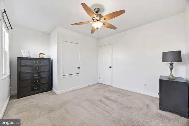 a view of an empty room with a dresser