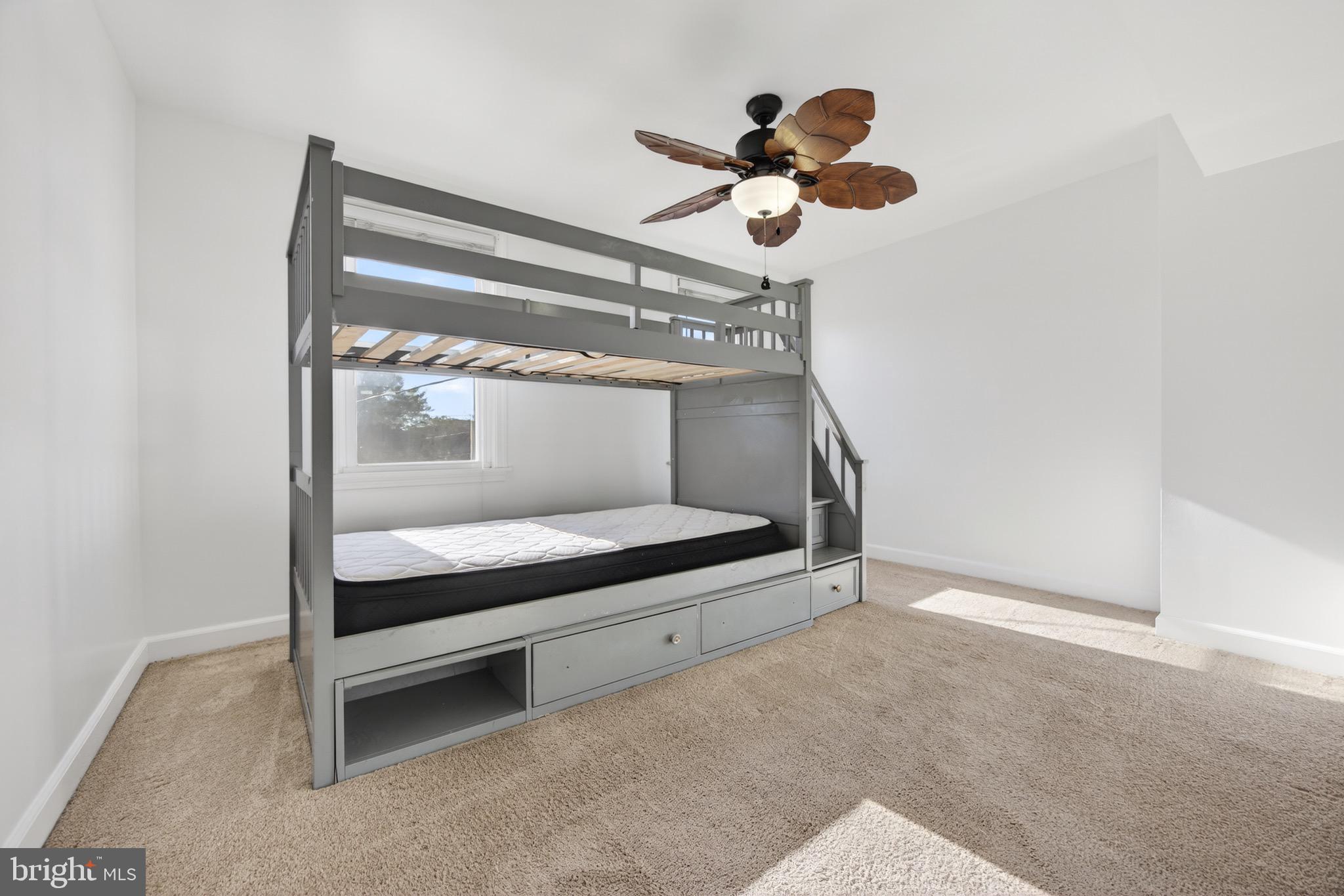 3579 Benzinger Road Baltimore, MD 21229 - Photo 24 of 34 a bedroom with a bed and a chandelier