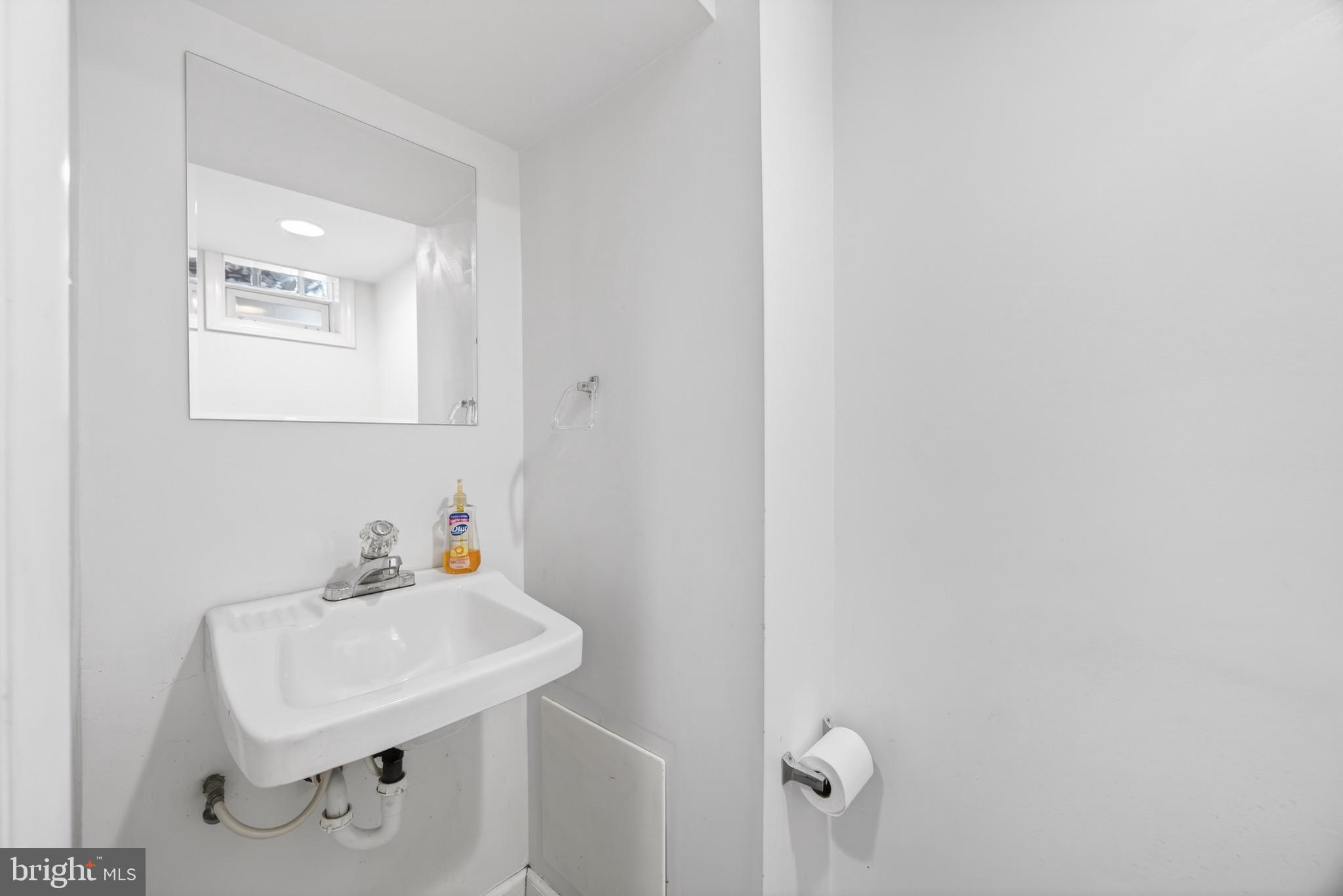 3579 Benzinger Road Baltimore, MD 21229 - Photo 27 of 34 a bathroom with a sink a mirror and vanity